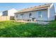 Backyard featuring grass and stone patio with outdoor furniture at 1696 Carlton Dr, Greenfield, IN 46140