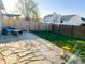 Backyard with stone patio, wood fence, and patio furniture under a pergola at 1696 Carlton Dr, Greenfield, IN 46140