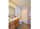 Bathroom features a single sink vanity and a shower with a patterned shower curtain at 1696 Carlton Dr, Greenfield, IN 46140