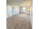 Spacious bedroom has large windows and plush carpeting with neutral walls at 1696 Carlton Dr, Greenfield, IN 46140