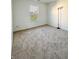 Bright, carpeted bedroom with a window overlooking the yard at 1696 Carlton Dr, Greenfield, IN 46140