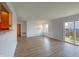 Spacious living room with laminate flooring, natural light, and access to the backyard at 1696 Carlton Dr, Greenfield, IN 46140