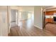 Open-concept living space flows into the kitchen, featuring wood-look flooring and natural light at 1696 Carlton Dr, Greenfield, IN 46140
