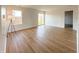 Bright living room with hardwood floors, large window, and sliding glass door at 1696 Carlton Dr, Greenfield, IN 46140