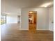 Open living room showcases wood-look floors and access to kitchen and outdoor space at 1696 Carlton Dr, Greenfield, IN 46140