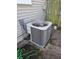 A close up of an air conditioner unit sitting on a stone slab beside a home's siding at 1710 Thaddeus St, Indianapolis, IN 46203