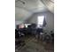 Versatile attic space with modern computer setup under a window that could be used as a bedroom or bonus room at 1710 Thaddeus St, Indianapolis, IN 46203