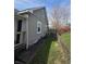 Backyard view with partial fence, showcasing outdoor space and the back of the house at 1710 Thaddeus St, Indianapolis, IN 46203