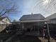 View of the home's backyard featuring a covered patio and a detached garage under a sunny sky at 1710 Thaddeus St, Indianapolis, IN 46203