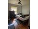 Well-lit bedroom with hardwood floors, a cozy rug, and ample natural light from the window at 1710 Thaddeus St, Indianapolis, IN 46203