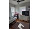 Bright bedroom with two windows, a ceiling fan, and kid-friendly decor creating a welcoming space at 1710 Thaddeus St, Indianapolis, IN 46203