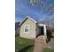 Charming single story home featuring light beige siding and a quaint brick walkway leading to the front entrance at 1710 Thaddeus St, Indianapolis, IN 46203