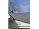 Close-up shot of the house's facade showcasing its number, roof and a hint of bare trees in the background at 1710 Thaddeus St, Indianapolis, IN 46203