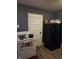 Features a white oven stove next to a black refrigerator, set against gray walls and wood flooring at 1710 Thaddeus St, Indianapolis, IN 46203