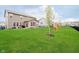 Spacious backyard featuring lush green grass, a play set, and a black fence at 17301 Tribute Row, Noblesville, IN 46060