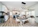 Bright, open kitchen with white cabinetry, a large island, and a dining area with modern lighting at 17301 Tribute Row, Noblesville, IN 46060