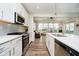 Bright kitchen with white cabinets, stainless steel appliances, and island seating at 17301 Tribute Row, Noblesville, IN 46060