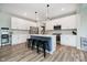 Bright kitchen with white cabinets, stainless steel appliances, and island seating at 17301 Tribute Row, Noblesville, IN 46060