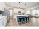 Bright kitchen with white cabinets, stainless steel appliances, and island seating at 17301 Tribute Row, Noblesville, IN 46060
