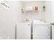 Laundry room with a washer, dryer, storage shelf, and laundry decor at 17301 Tribute Row, Noblesville, IN 46060