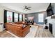 Cozy living room featuring a large sectional sofa, modern fireplace, and ample natural light at 17301 Tribute Row, Noblesville, IN 46060