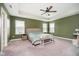 A spacious main bedroom features natural light, a ceiling fan, and neutral decor at 17301 Tribute Row, Noblesville, IN 46060