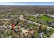 Expansive aerial view of a neighborhood with lush trees and a charming home with a pool in the backyard at 1736 Sandoval Ct, Indianapolis, IN 46214