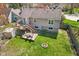 Aerial view of large backyard deck, firepit, and green lawn in this well maintained property at 1736 Sandoval Ct, Indianapolis, IN 46214