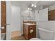 Bathroom vanity featuring wood cabinets, mirror, modern lighting, and neutral colors at 1736 Sandoval Ct, Indianapolis, IN 46214