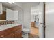 Bathroom with wood cabinet vanity, sink, and toilet at 1736 Sandoval Ct, Indianapolis, IN 46214