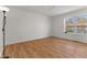Bright bedroom with hardwood floors, a ceiling fan, and a large window offering natural light at 1736 Sandoval Ct, Indianapolis, IN 46214