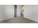Bedroom with neutral paint and carpeting as well as a closet and entry to laundry room at 1736 Sandoval Ct, Indianapolis, IN 46214