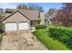 Charming two-story home with a well maintained front yard and a two car garage at 1736 Sandoval Ct, Indianapolis, IN 46214