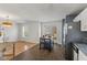 Open concept view of kitchen featuring stainless steel fridge, island seating, and access to the home's living room at 1736 Sandoval Ct, Indianapolis, IN 46214
