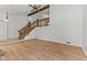 Spacious living room with wood floors and staircase leading to another level in the home at 1736 Sandoval Ct, Indianapolis, IN 46214