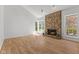 Bright living room featuring a stone fireplace, wood floors, and large windows for lots of natural light at 1736 Sandoval Ct, Indianapolis, IN 46214