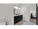 Well-lit double vanity bathroom with black cabinets, patterned tile floor, and modern fixtures at 1818 Orleans St, Indianapolis, IN 46203