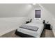 A cozy bedroom has neutral carpet, a black bed frame and bedside tables, and a window that lets in natural light at 1818 Orleans St, Indianapolis, IN 46203