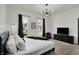 Bright bedroom featuring a modern chandelier, and sleek black furniture providing a comfortable retreat at 1818 Orleans St, Indianapolis, IN 46203