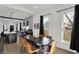 Open-concept dining room with modern table set, black accents, and an eat-in kitchen at 1818 Orleans St, Indianapolis, IN 46203