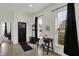 Bright entryway with vinyl floors, coat rack, front door and natural light from the front windows at 1818 Orleans St, Indianapolis, IN 46203