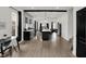 Open kitchen with black cabinets, white countertops, an island with seating, and stainless steel appliances at 1818 Orleans St, Indianapolis, IN 46203