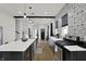Well-designed kitchen with an island and breakfast bar, stainless appliances, and laminate floors at 1818 Orleans St, Indianapolis, IN 46203