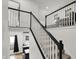 Bright staircase with white railings and black trim, leading to an upper level at 1818 Orleans St, Indianapolis, IN 46203