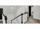 Carpeted staircase with black and white railings leading to the second story at 1818 Orleans St, Indianapolis, IN 46203