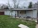 Image of a backyard featuring a covered patio and modest home with white siding at 1830 S Chester Ave, Indianapolis, IN 46203