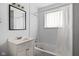 Functional bathroom featuring a classic vanity, a well-lit mirror, and a practical bathtub at 1842 W Kessler Blvd N Dr, Indianapolis, IN 46228