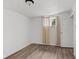 This bedroom features wood-look flooring, neutral walls, and natural light from the window at 1842 W Kessler Blvd N Dr, Indianapolis, IN 46228