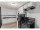 Modern kitchen with stainless steel appliances, white cabinets, and wood flooring at 1842 W Kessler Blvd N Dr, Indianapolis, IN 46228