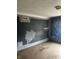 A room with patchy blue walls, worn floors and an air vent at 205 S 8Th St, Noblesville, IN 46060